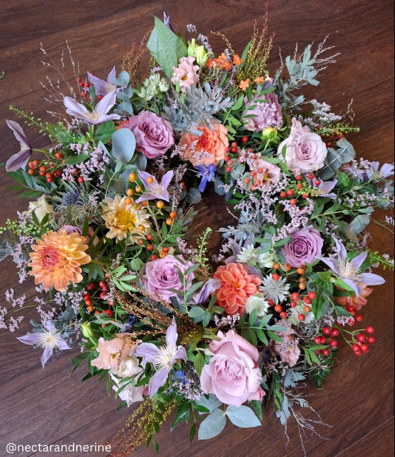 Loose garden style wreath floral tribute with lavender and peach flowers